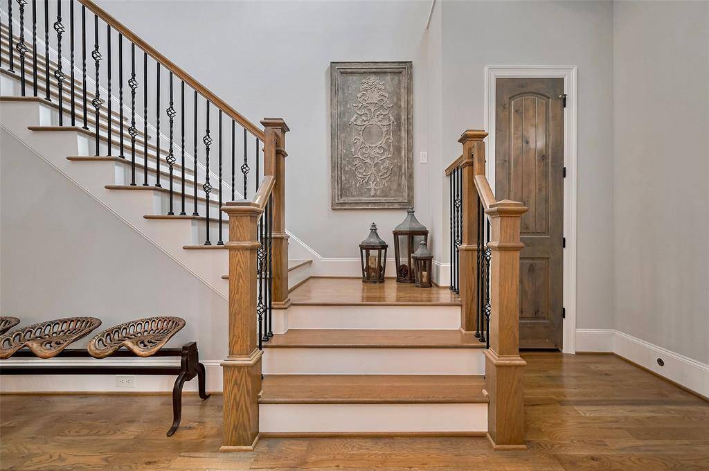A true architectural centerpiece, the extra-wide staircase makes a bold yet refined statement in the home. Crafted from solid oak, each step showcases the natural beauty and durability of the wood, creating a warm and timeless foundation. Oil-rubbed bronze wrought iron balusters add a touch of old-world charm and artistry, perfectly complementing the rich tones of the oak.
