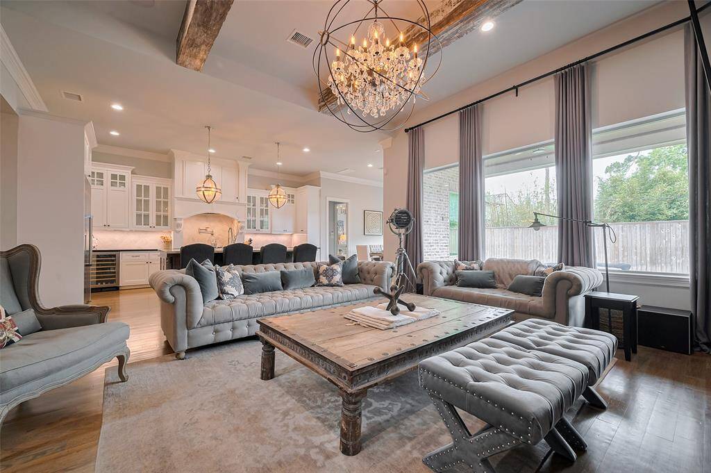 This light-filled living room seamlessly flows into the heart of the home—the kitchen—creating an open, connected space perfect for everyday living and entertaining
