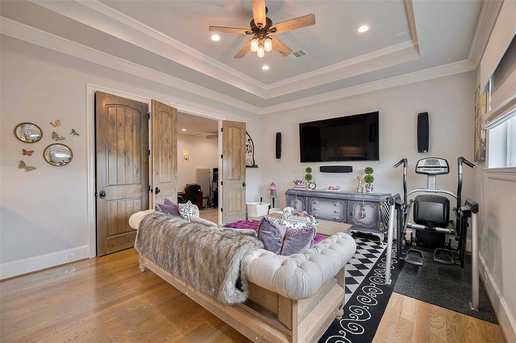 The game room offers a stylish and comfortable retreat, featuring a tray ceiling with built-in speakers for immersive sound. Custom Roman shades add a tailored touch, while its location adjacent to the media room makes it ideal for entertaining and relaxing alike.