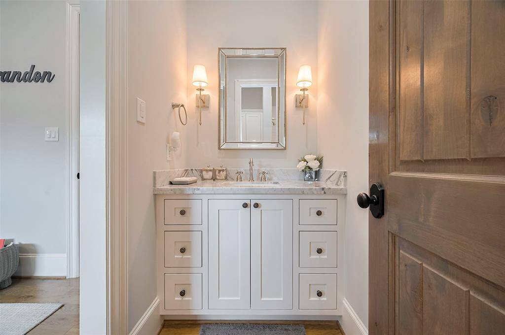 The Jack and Jill bathroom offers convenience and privacy, with each secondary bedroom featuring its own sink and custom cabinetry. Thoughtfully designed for shared living without compromising personal space.