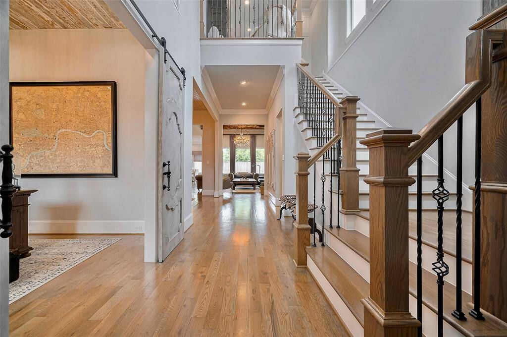 Step into a light-filled foyer that sets the tone for the elegance found throughout the home. Natural light pours in, highlighting the open, airy design and the fine details that greet you upon entry.
