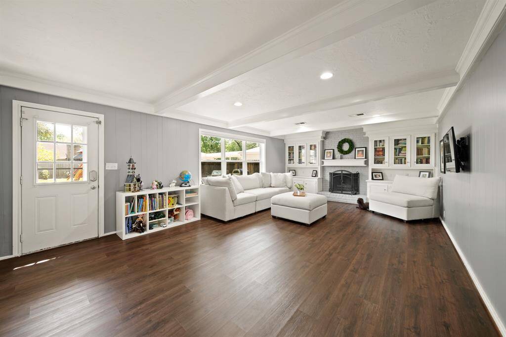 Living room features beautiful flooring, recessed lighting, and access to the backyard.