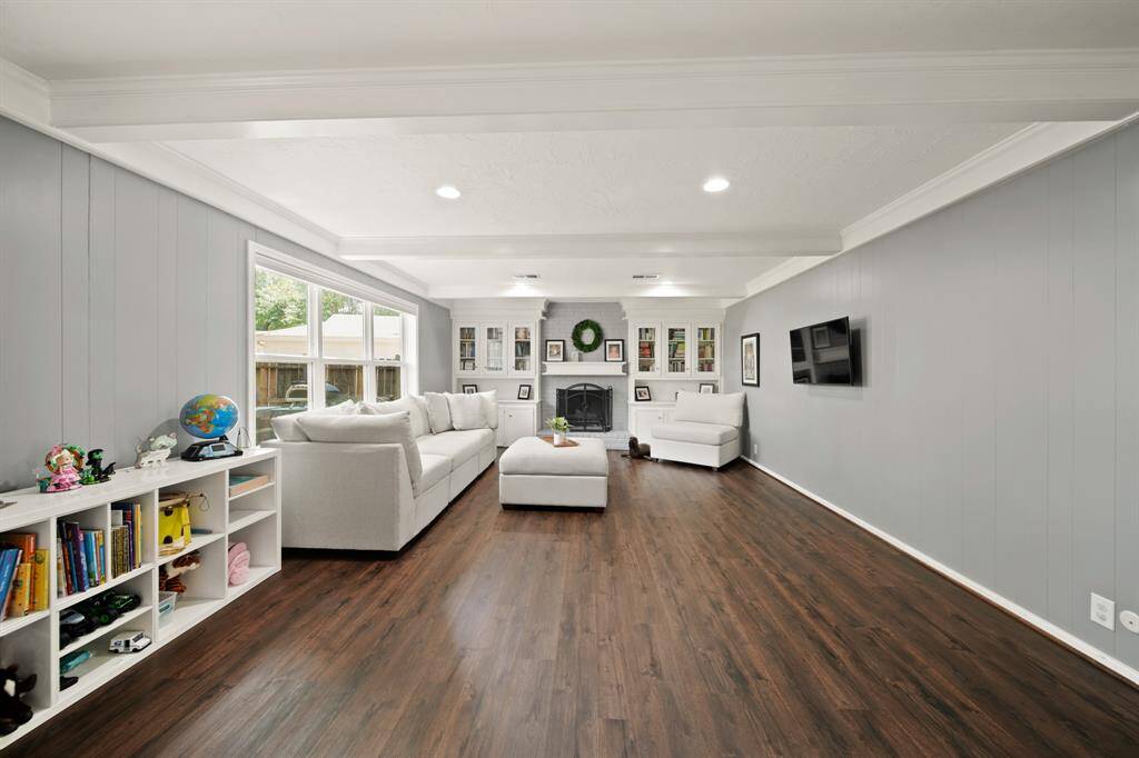 Living room features beautiful flooring, recessed lighting, and access to the backyard.