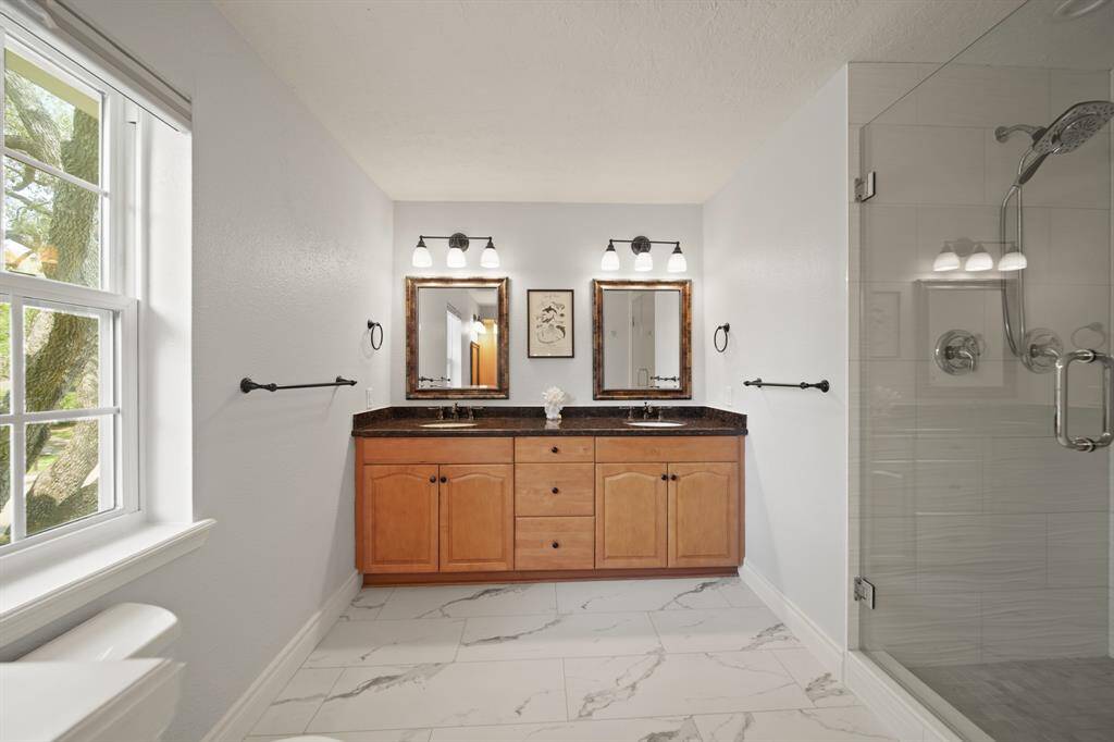 The primary bathroom has extensive upgrades including the huge walk-in shower and two primary closets!