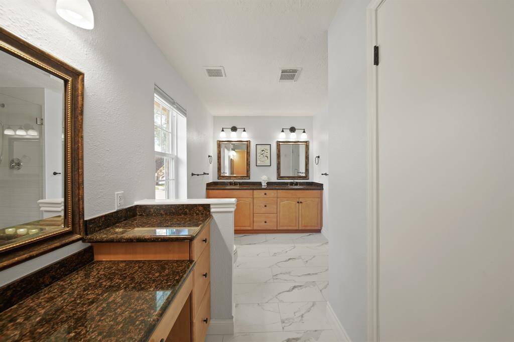 The primary bathroom also has a vanity area.