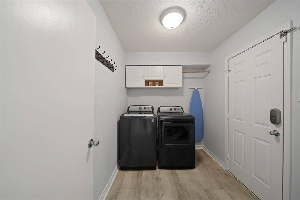 The laundry room features washer and dryer connections andplenty of storage space.