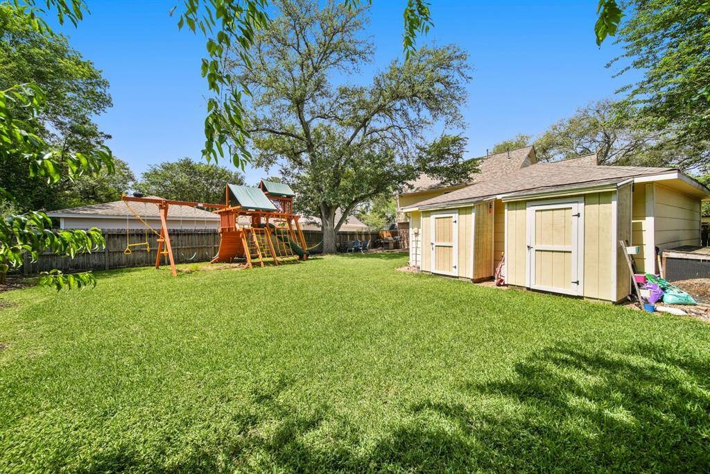 The backyard also has a storage shed and compost box. This backyard is a gardner's dream.