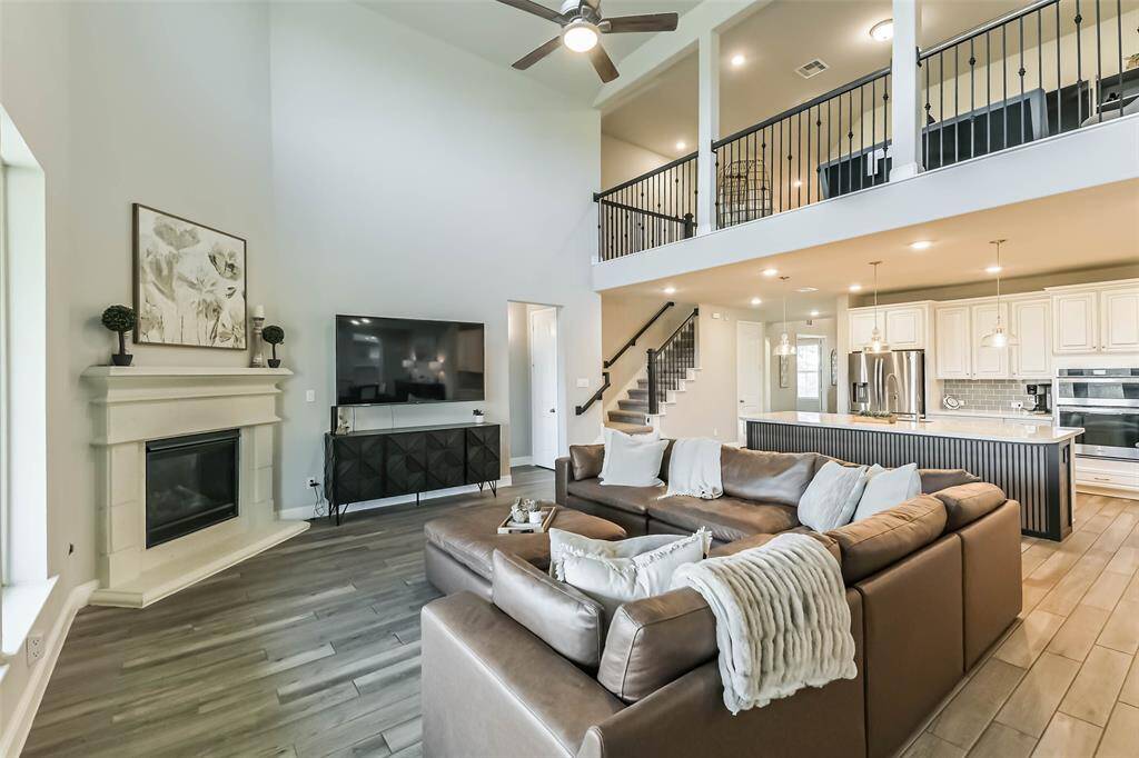 Living room flows together with the amazing kitchen, overlooked by the game room balcony.