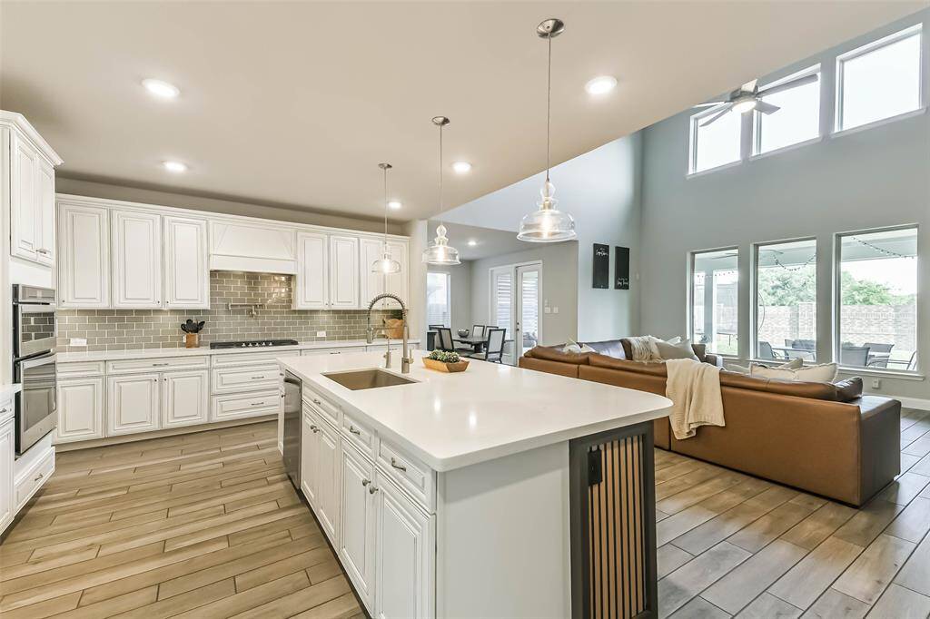 There is so much space in this kitchen that the whole family could create dishes at the same time and not run into each other. Storage and more storage in these upgraded cabinets, all with a view to the backyard with no back neighbors.