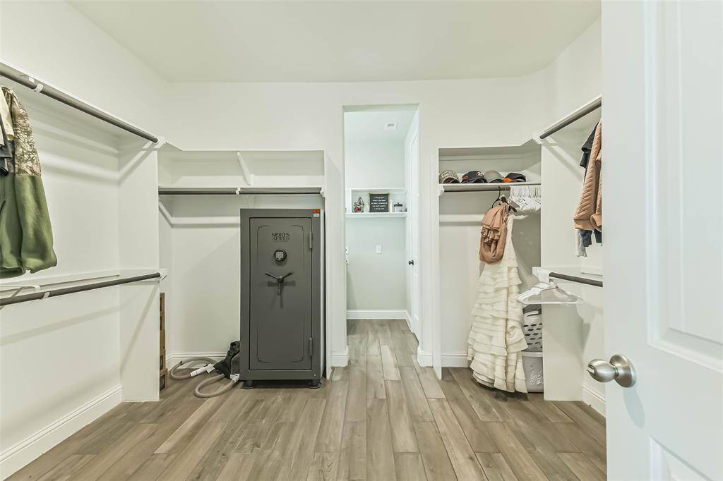 Huge primary closet leads from the primary bathroom with an opening to the laundry room.