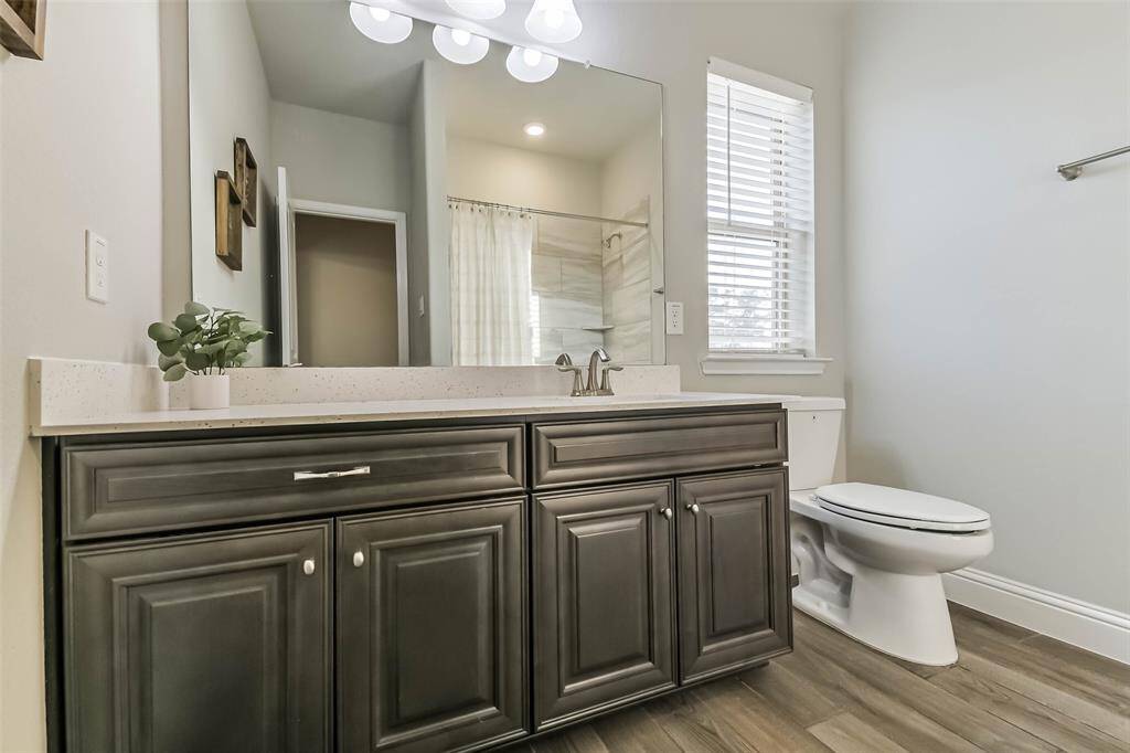 Upstairs hall bath has tub/shower combination and extra cabinet storage.