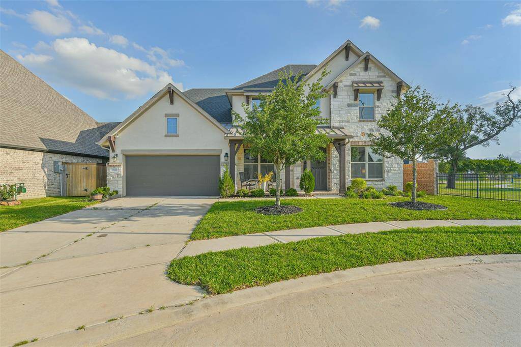 Home has stone, brick, and stucco with corbel details and a metal roof over the porch for that Hill Country feel