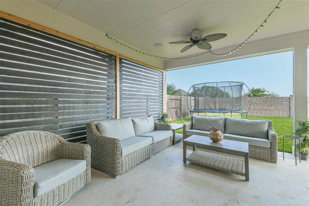 This extended covered back porch has custom vented privacy screen, ceiling fans, TV mount, and plenty of space for relaxing or entertaining with a view towards the gorgeous Amira sunsets and no back neighbors.