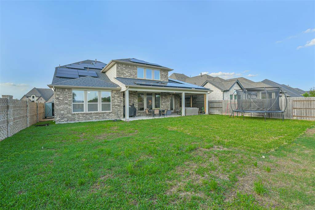 Home has full gutters, sprinkler system, and solar panels for energy efficiency.