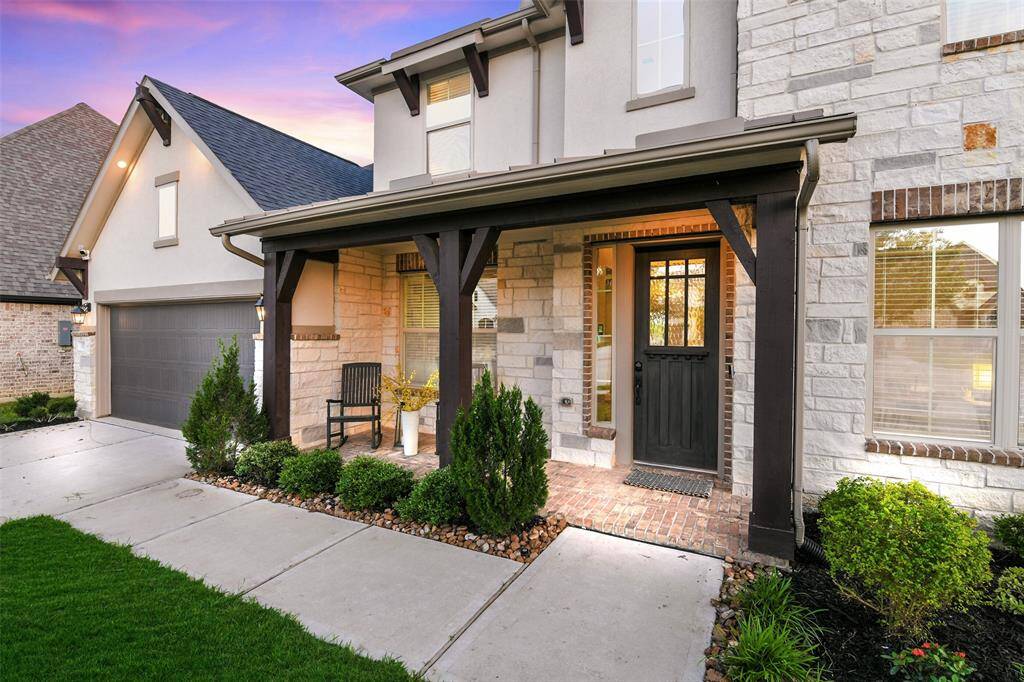 Wide bricked front porch with cedar posts is a perfect place to enjoy the evening sunset over the park or the activities in the culdesac.