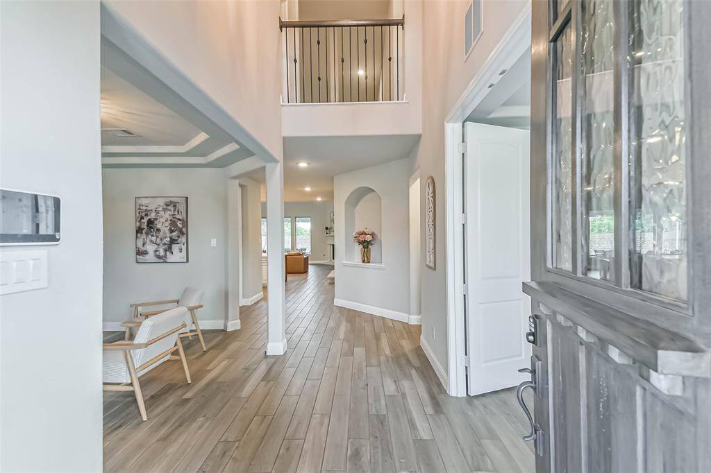 Wood look tile and a 2-story entry welcome you into this gorgeous home.