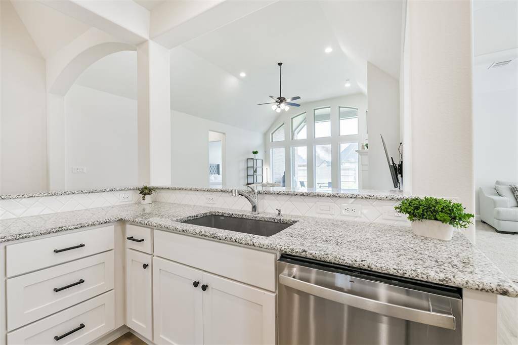 From the kitchen sink, you can still see the main living areas and even look out to the large backyard and covered porch.