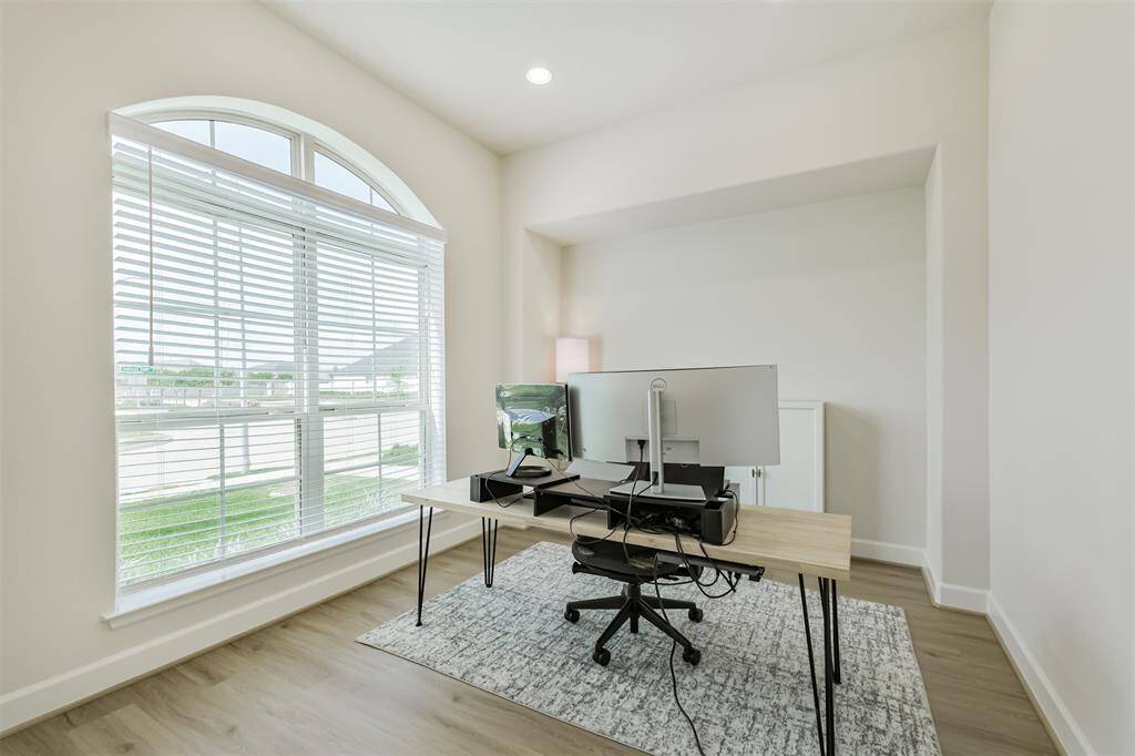 Spacious study with arched windows and plenty of light.