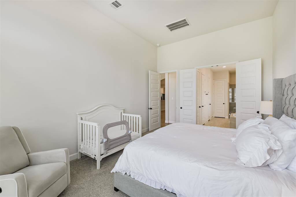 Primary bedroom leads to a luxury bathroom suite.