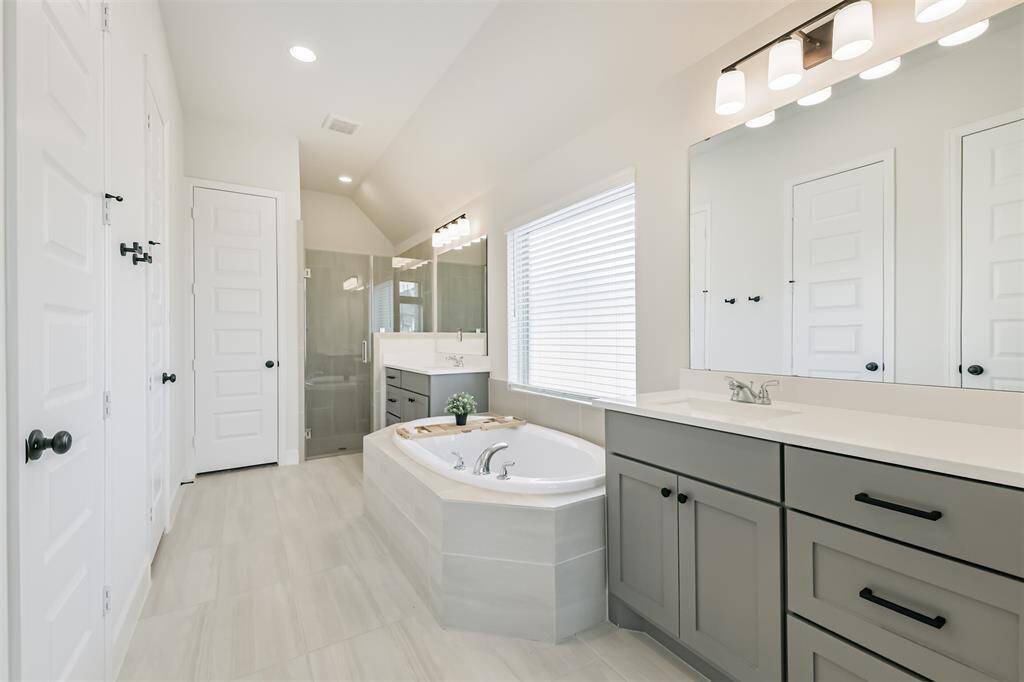 Double sinks, ample storage, soaking tub, linen closet, separate shower, and 2 walk-in closets make this bathroom a true retreat.