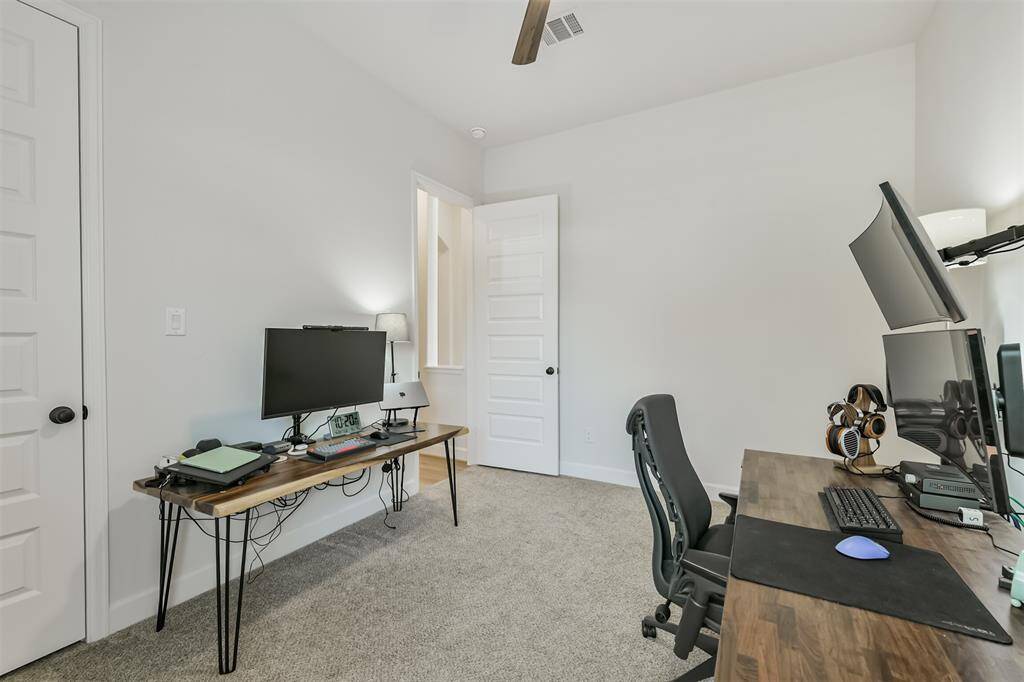 Second bedroom with ceiling fan and walk-in closet
