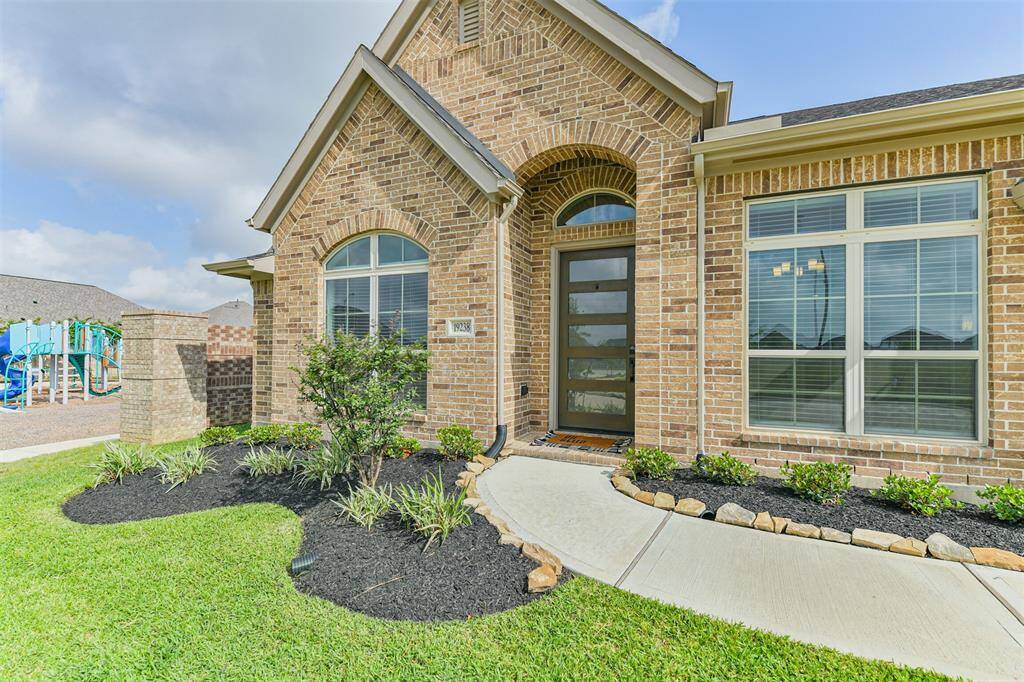 Brick wall separates this nearly new home from the playground.