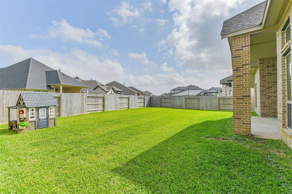 Large backyard provides room for a pool or other outdoor activities.