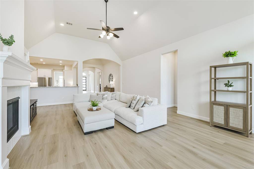 This light and bright living room is the hub of the home, connected to the kitchen, breakfast room game room, primary suite, and 4th bedroom suite.