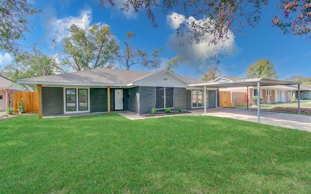 This beautiful updated single-story home has some real curb appeal! The dark brick exterior paired with clean white trim gives it a fresh, modern vibe. Those big front windows bring in tons of natural light, perfect for a bright, open feel inside. The driveway flows right up to a convenient carport, and the well-kept lawn and mature trees give the whole place a warm, welcoming touch.