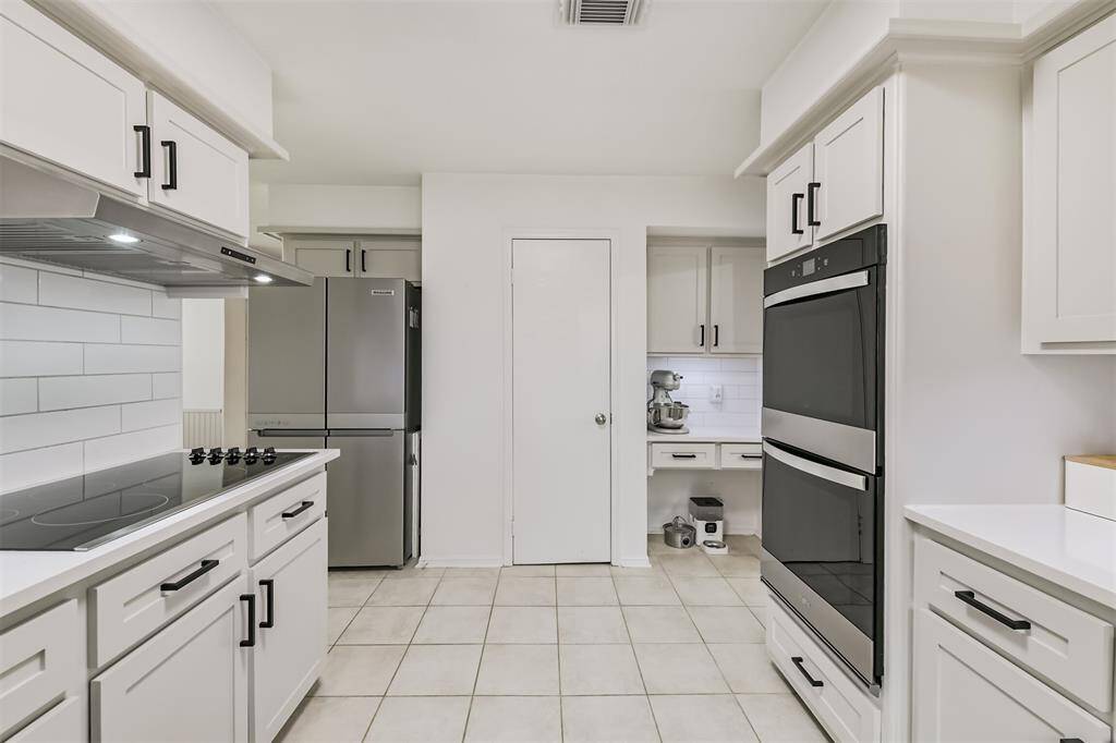 Standing in the kitchen looking back towards the pass through area. Don't miss that built-in desk area!