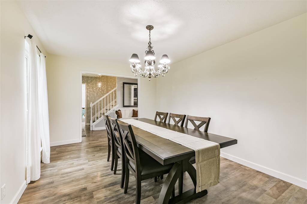 With view overlooking the front lawn, you'll find the natural light filling in all the corners. This view is from standing in the dining room looking back towards the entryway.