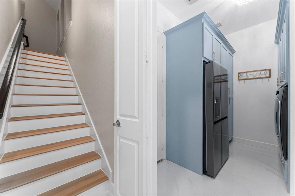 View of the back set of stairs off the laundry room (access to the 3 car garage).