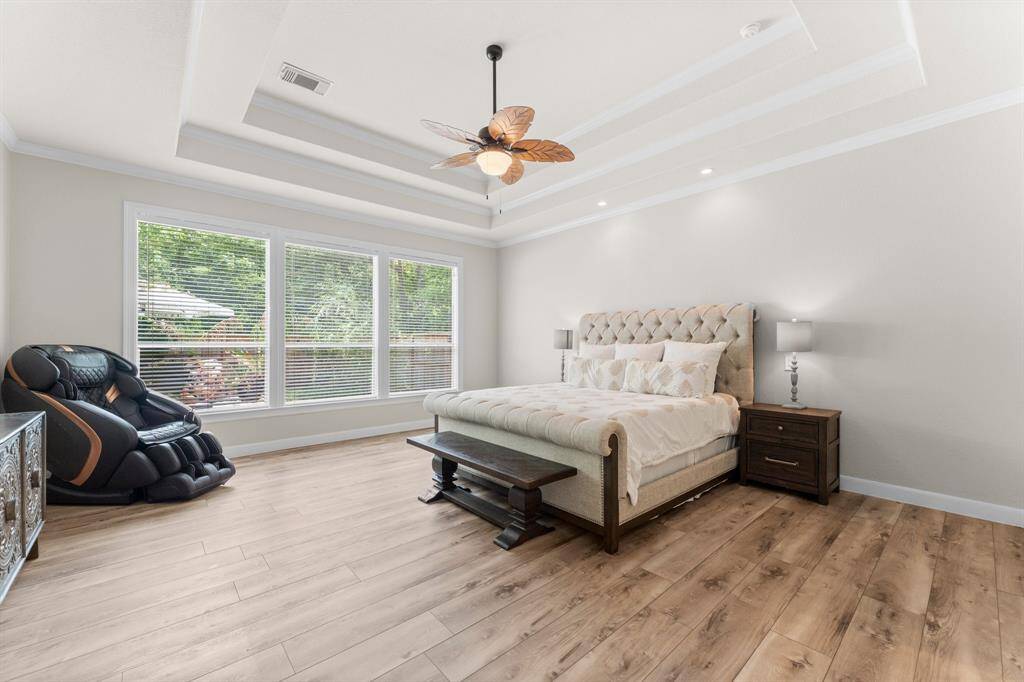Primary bedroom overlooking the sparkling pool.