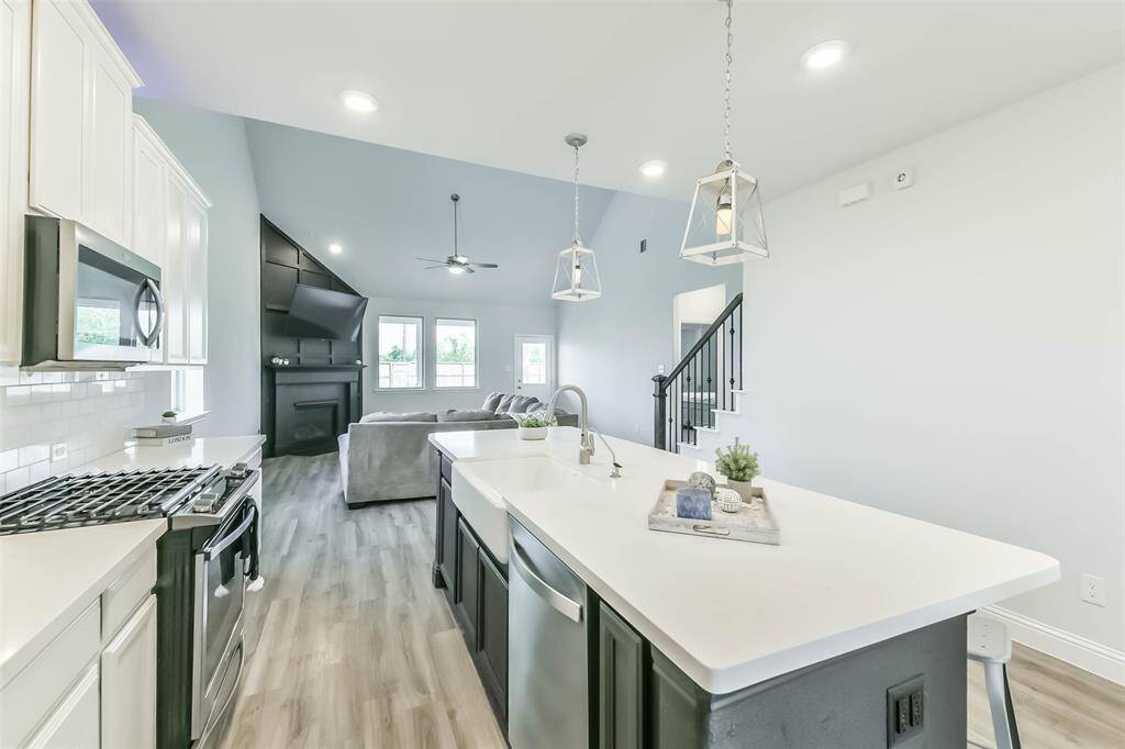 Light and bright kitchen is open to living room for seamless entertaining.