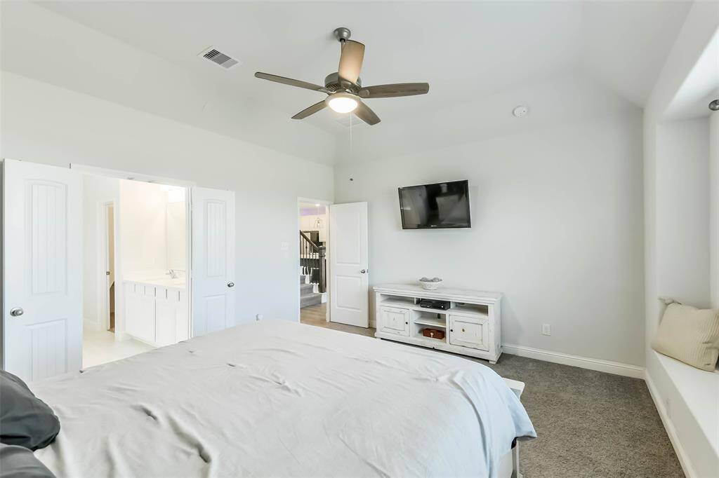 Spacious primary bedroom opens to a luxury bath.