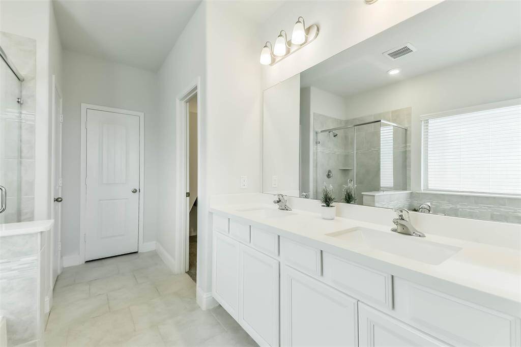 This bathroom has lots of natural light, plus a linen closet and large walk-in closet.