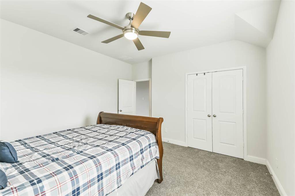 Second bedroom with ceiling fan and large closet.