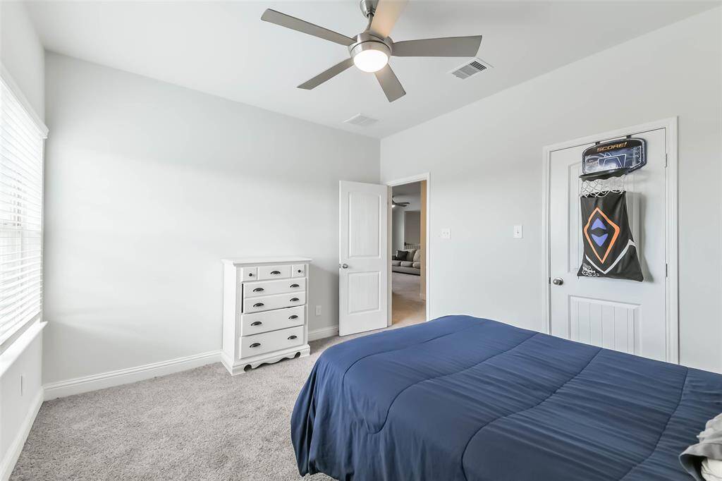 Third bedroom with ceiling fan and walk-in closet