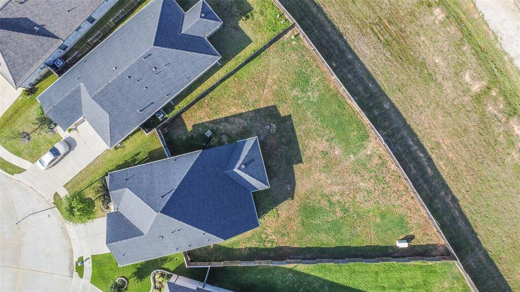 Huge yard with generator in the back corner and lake behind. Imagine all the things you could do with this yard!