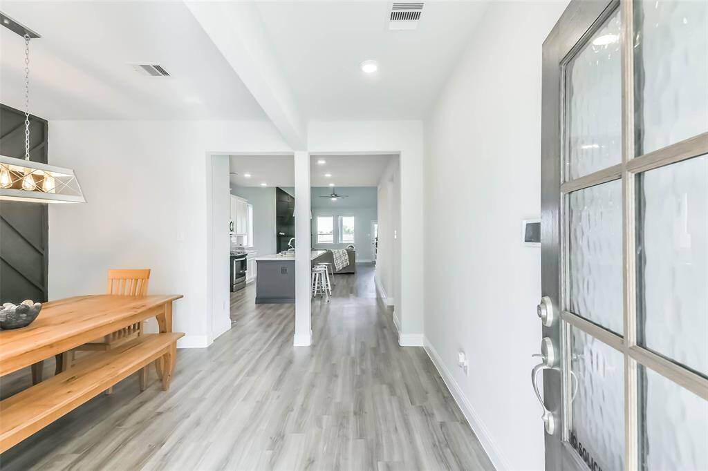 LVP flooring flow through the house. Formal dining to the left of the entry.