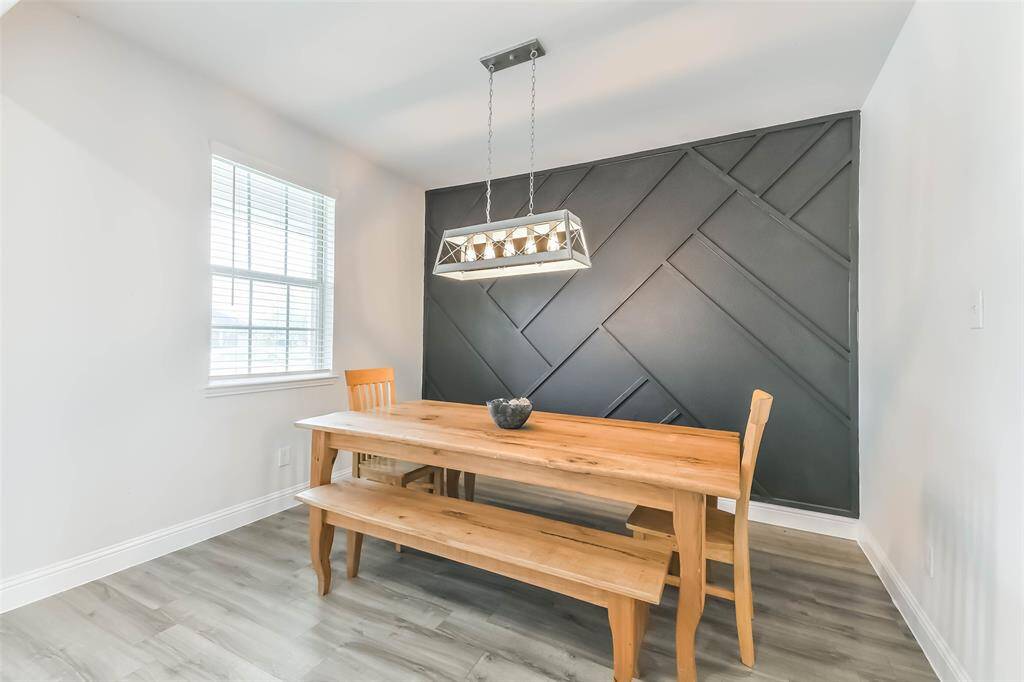 Formal dining has black accent wall, upgraded light fixture, and plenty of room for a large table.