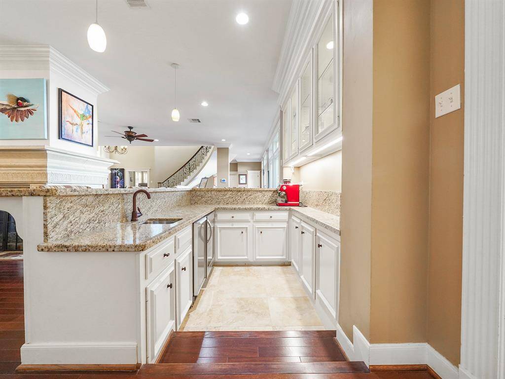This inviting space is equipped with a sink, an ice maker, and a dedicated drink refrigerator, ensuring that you have all the essentials for entertaining guests or enjoying a relaxing evening at home.