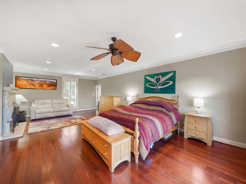 Luxurious primary retreat designed to offer an unparalleled blend of comfort and elegance. This expansive bedroom accommodates a king-size bed with ease, complemented by a cozy sitting area featuring a charming fireplace—perfect for relaxation.
