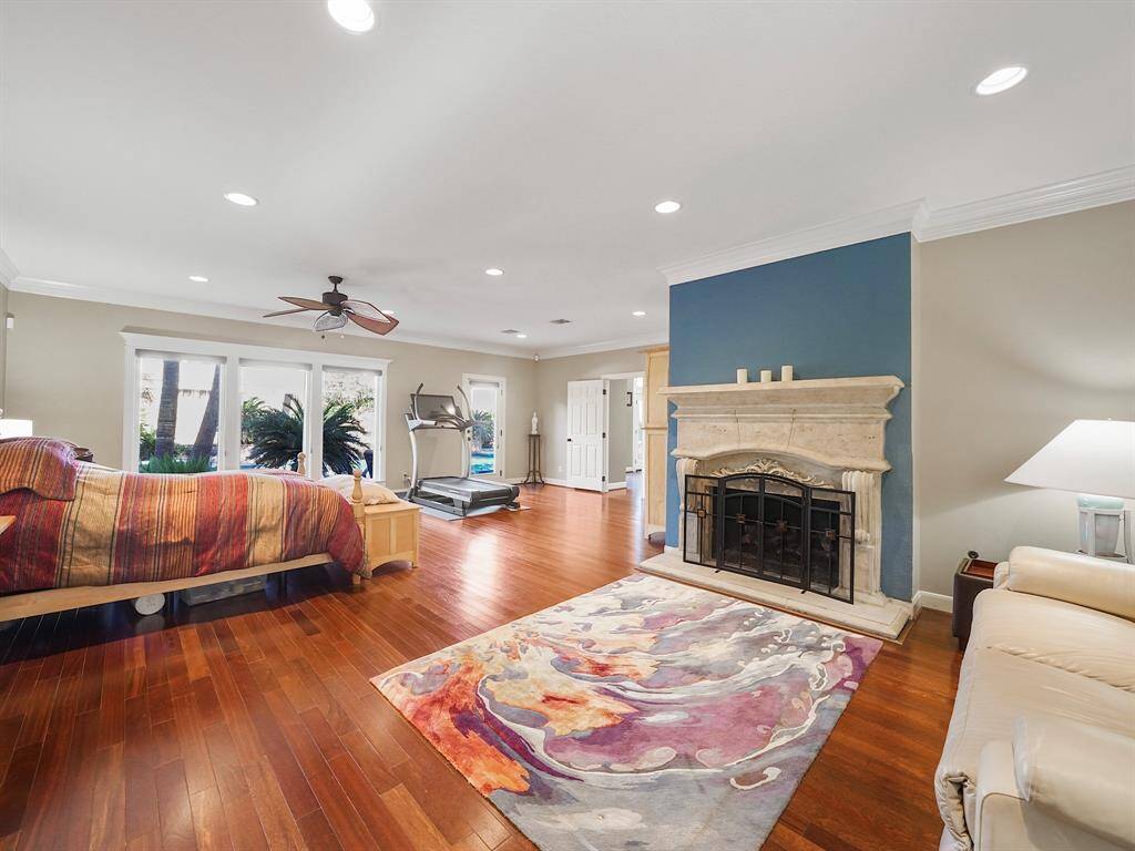 Featuring large windows that not only bathe the room in natural light but also provide serene views of the meticulously landscaped backyard. With direct access to the pool, this retreat seamlessly blends indoor comfort with outdoor leisure.