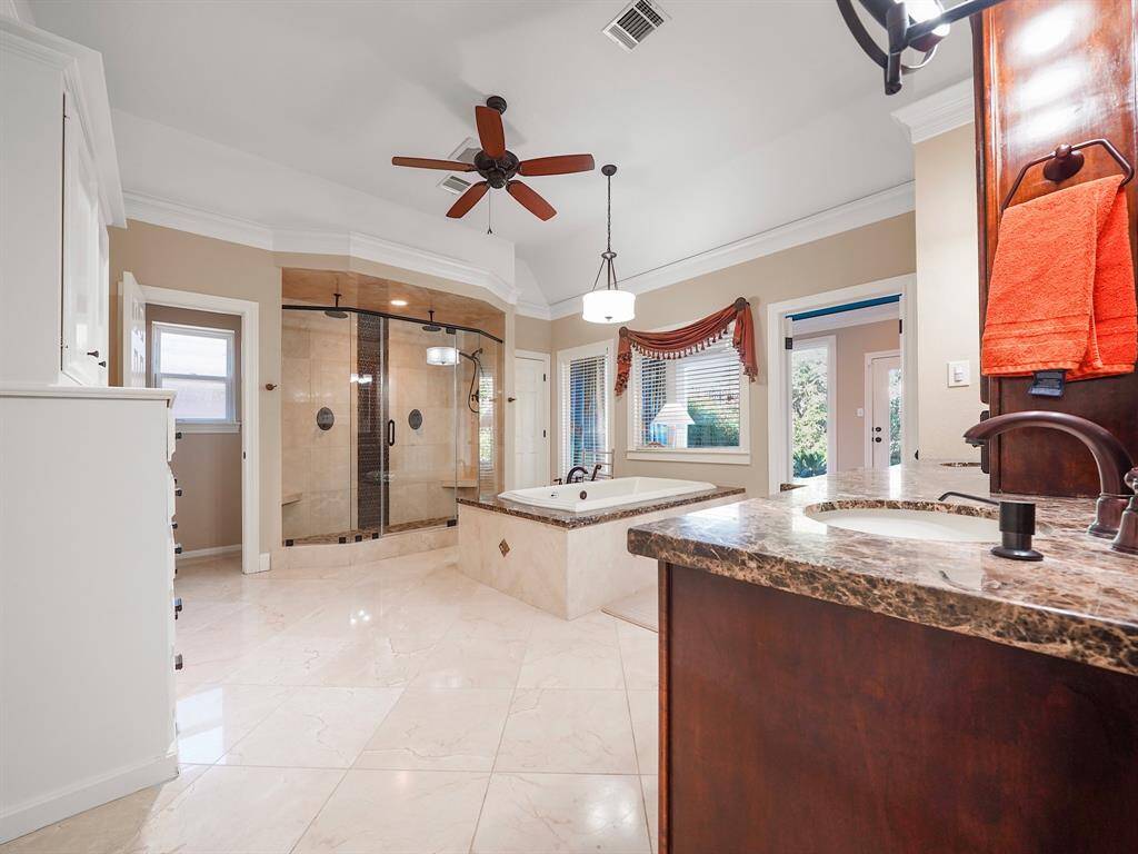 Discover the epitome of luxury in this primary bedroom's spa-like ensuite bathroom, designed to offer a tranquil retreat. Featuring exquisite granite countertops, elegant marble flooring, and dual sinks, this bathroom combines both style and functionality. With two spacious linen closets, you'll find ample storage for all your essentials.