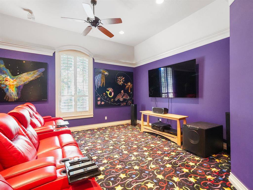 Welcome to your dream media room! This stunning space features a dramatic vaulted ceiling that adds an elegant touch, complemented by exquisite crown molding and decorative carpeting. With a spacious walk-in closet and an ensuite bathroom, this versatile room can easily be transformed into an additional bedroom, offering both comfort and convenience.