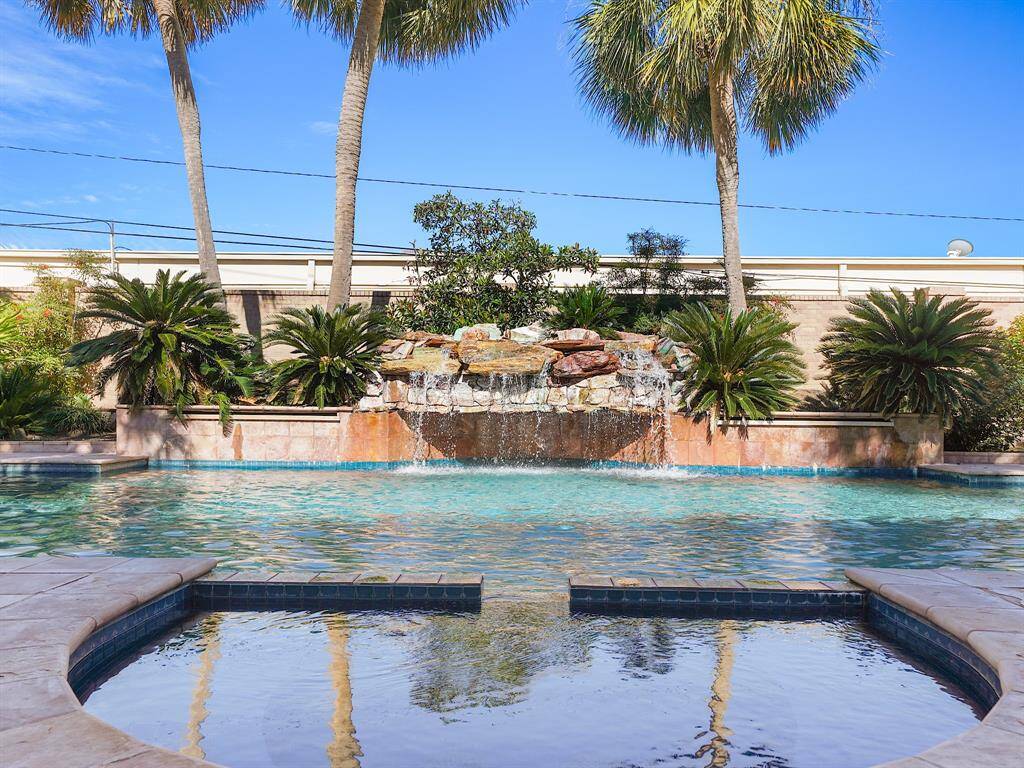 Dive into luxury with this immaculate heated pool, featuring a stunning waterfall that creates a serene oasis right in your backyard. Relax and unwind in the inviting hot tub, perfectly complemented by lush landscaping that offers a picturesque backdrop for your outdoor retreats.