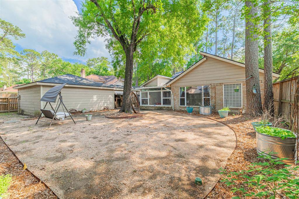 Detached 2 car garage and a nicely sized backyard with large trees providing privacy and shade.