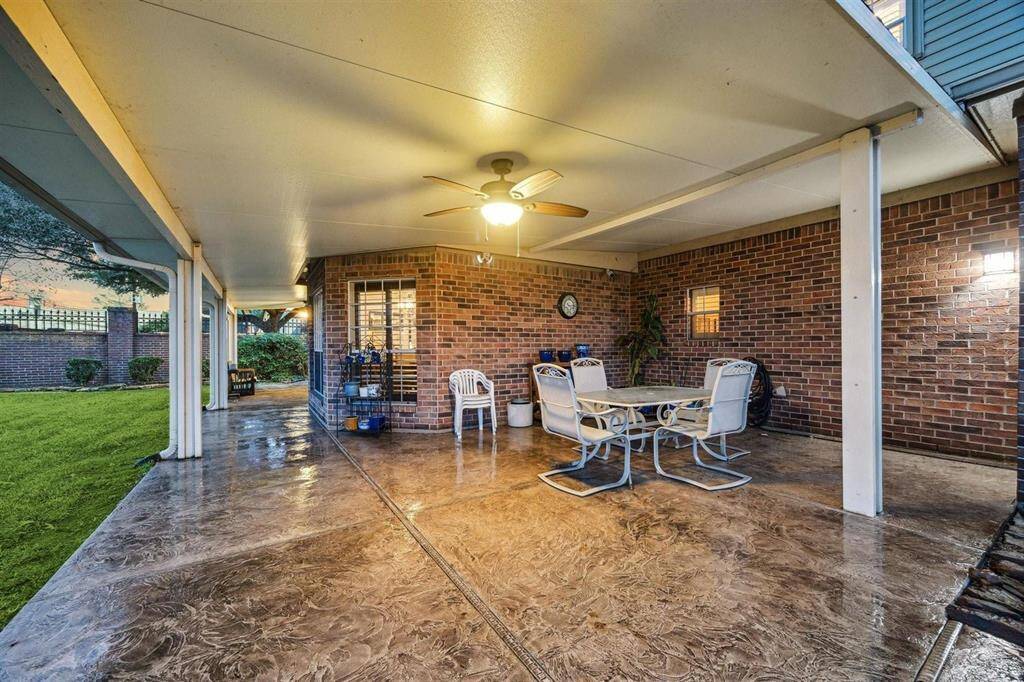 Entertain in comfort on this expansive covered patio, complete with textured concrete flooring, ceiling fans, and plenty of room for outdoor dining and lounging. This space is designed for year-round enjoyment, seamlessly connecting indoor luxury with outdoor living.