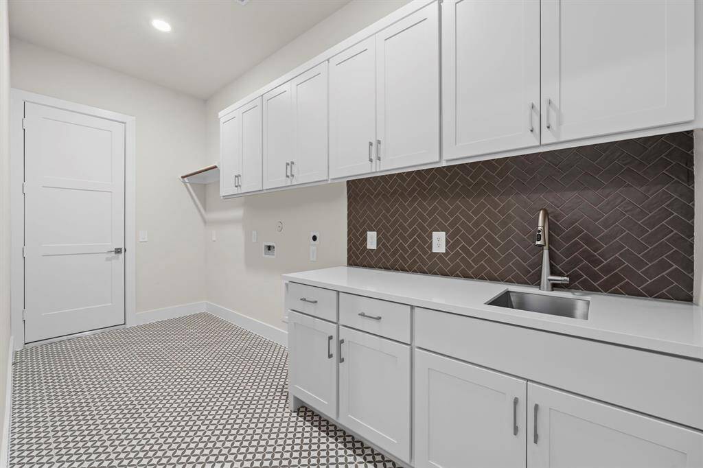 Utility Room with Sink, Storage Cabinets, and Washer and Dryer Connections